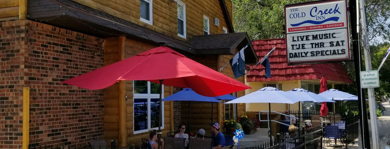 The Cold Creek Inn patio and sign in Beulah, Michigan