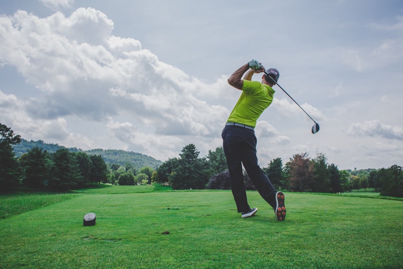 Golfer teeing off on a fairway